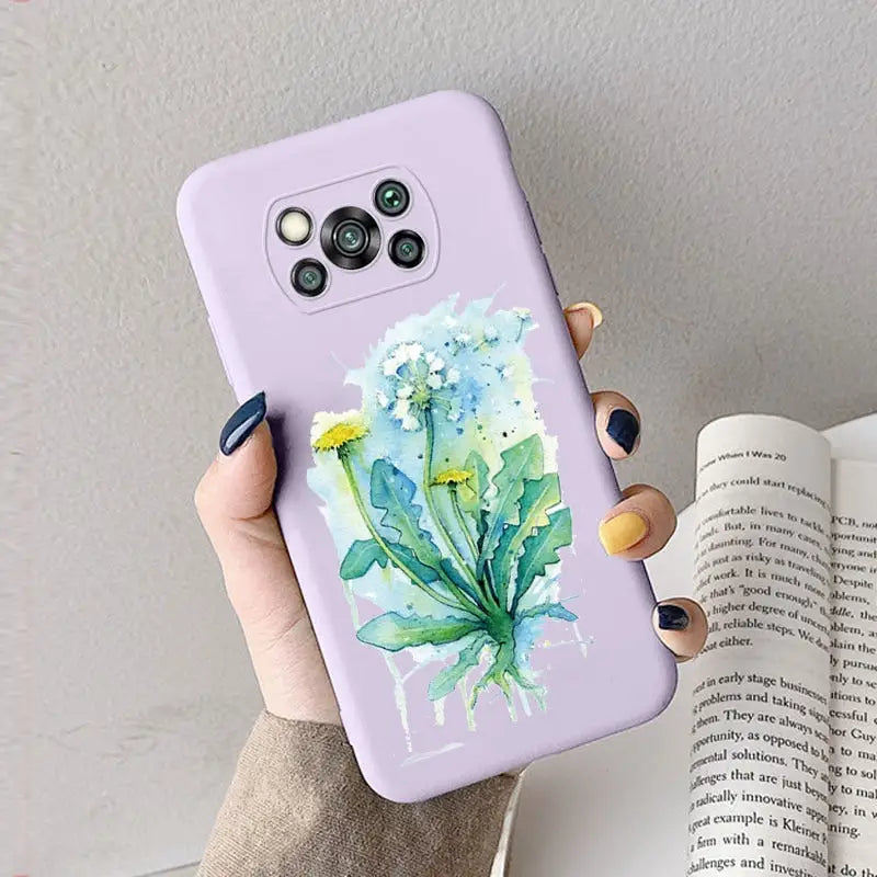 a woman holding a phone case with a watercolor painting of flowers