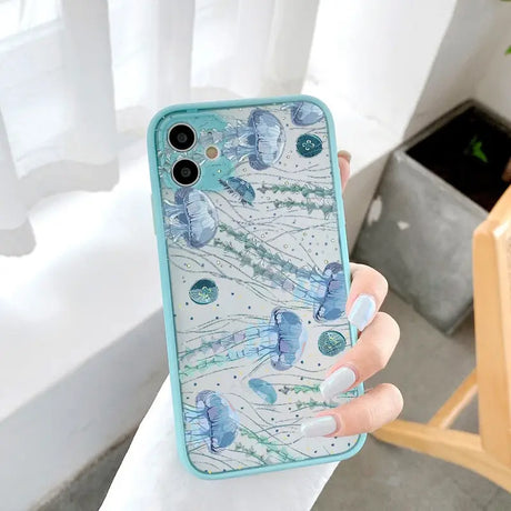 A woman holding a phone case with watercolor paint