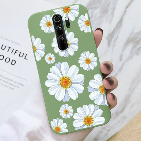 A woman holding a phone case with white flowers on it