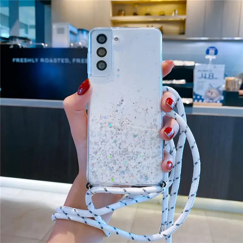 A woman holding a phone case with a white and blue marble pattern