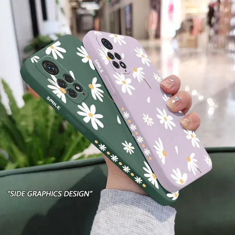 A woman holding a phone case with white flowers on it