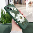 A woman holding a phone case with white flowers on it