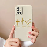 a woman holding a phone case with the word faith hope