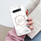 a woman holding a phone case with the words enjoy me on it