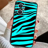 A woman holding a phone case with zebra print