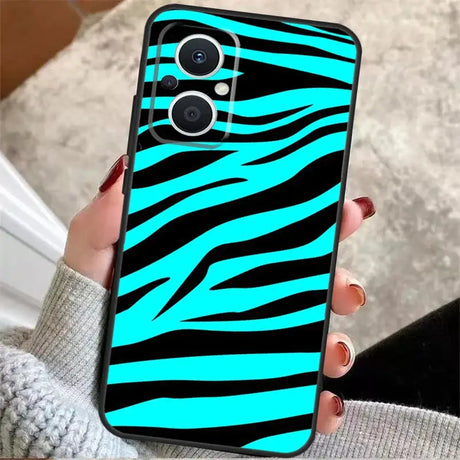 A woman holding a phone case with zebra print