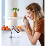 A woman using her phone to drink from a cup
