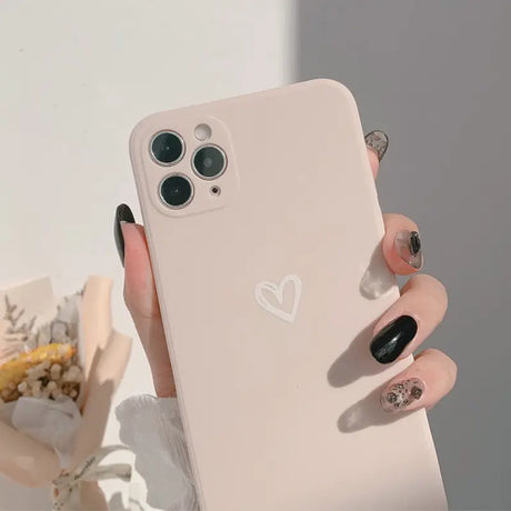 A woman holding a phone with a heart on it