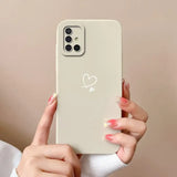 a woman holding a phone with a heart on it