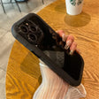 A woman holding a phone with a starbucks cup in the background