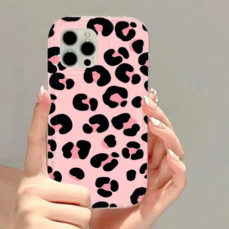 A woman holding a pink and black phone case