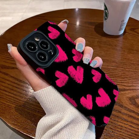 A woman holding a pink and black phone case