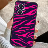 a woman holding a pink and black phone case