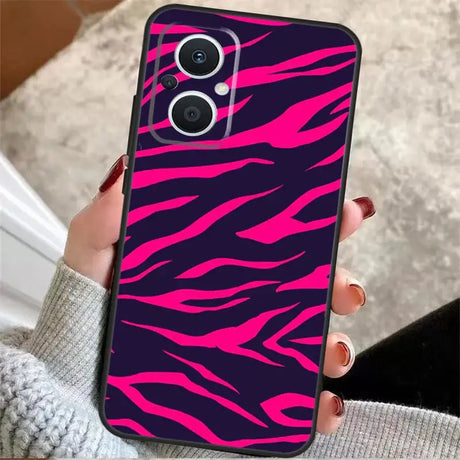 A woman holding a pink and black phone case