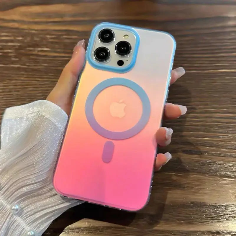 a woman holding a pink and blue iphone case