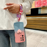 A woman holding a pink and blue phone case