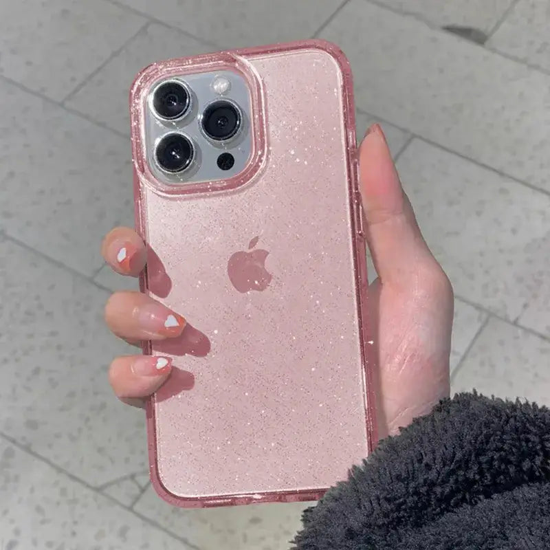 a woman holding a pink glitter iphone case