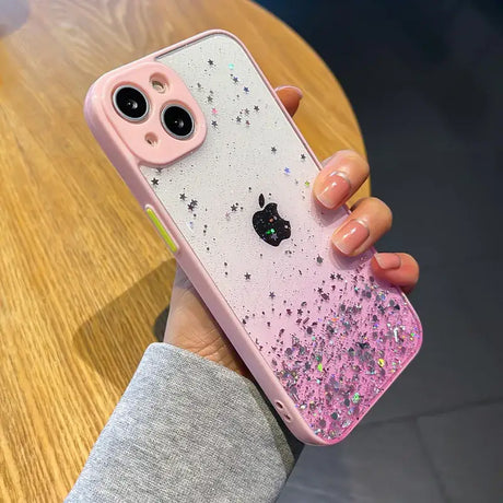 A woman holding a pink iphone case with glitter and stars