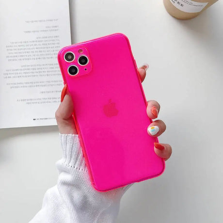 a woman holding a pink iphone case