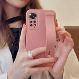 a woman holding a pink iphone case