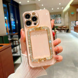 a woman holding a pink iphone case with a diamond case