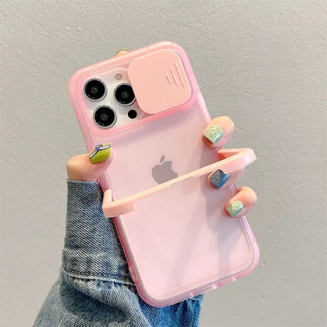 a woman holding a pink iphone case