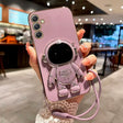 a woman holding a pink phone case with a camera attached to it