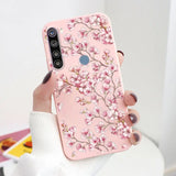 a woman holding a pink phone case with a pink flower design