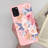 a woman holding a pink phone case with flowers on it