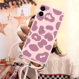 a woman holding a pink phone case with a pink leopard print