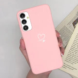 a woman holding a pink phone case with a heart on it
