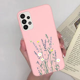 a woman holding a pink phone case with flowers on it