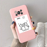 a woman holding a pink phone case with a cartoon cat