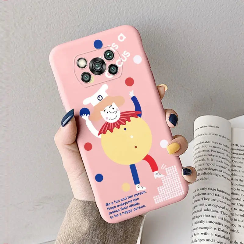 a woman holding a pink phone case with a cartoon character on it