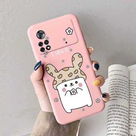 A woman holding a pink phone case with a cartoon dog on it