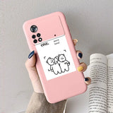 a woman holding a pink phone case with a cartoon cat on it