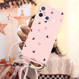 a woman holding a pink phone case with hearts on it