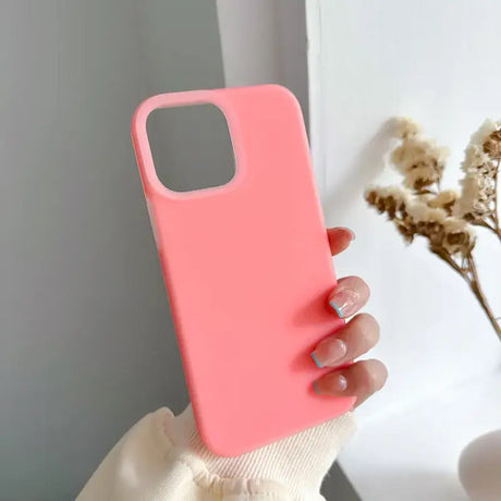 A woman holding a pink phone case