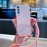 a woman holding a pink phone case with glitter