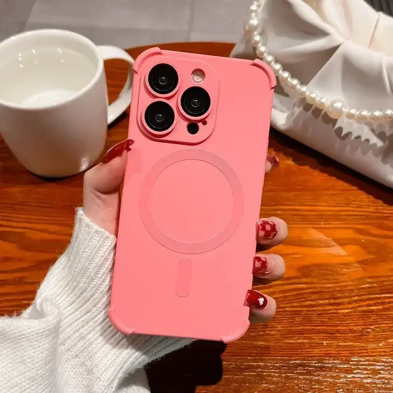 a woman holding a pink phone case