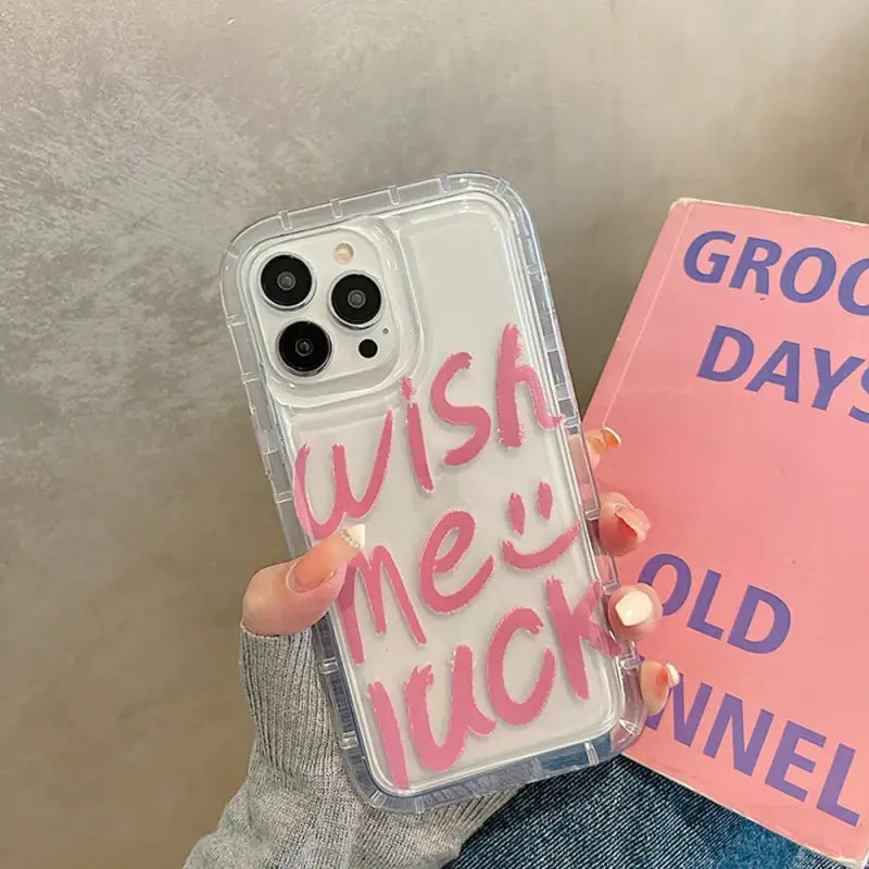 a woman holding a pink phone case with the words good day