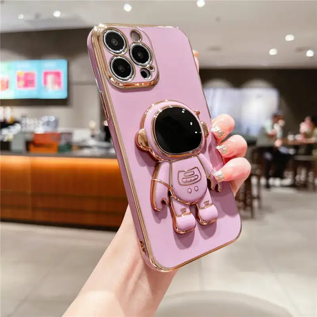 A woman holding a pink phone case with a camera