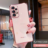 a woman holding up a pink phone case