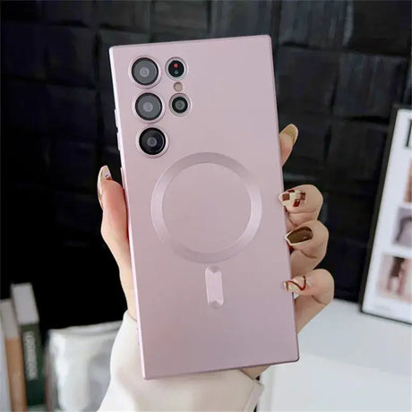 A woman holding up a pink phone case