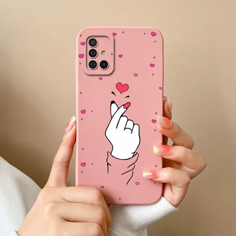 a woman holding a pink phone case with a heart on it