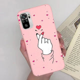 a woman holding a pink phone case with a heart on it