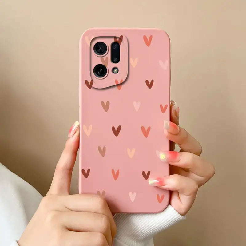 A woman holding a pink phone case with hearts on it