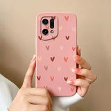 a woman holding a pink phone case with hearts on it