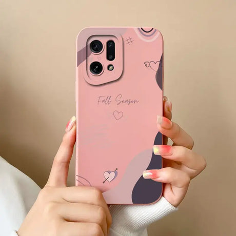 A woman holding a pink phone case with a heart design