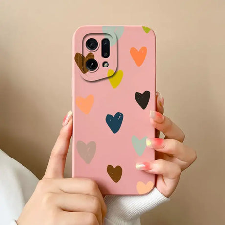 A woman holding a pink phone case with hearts on it